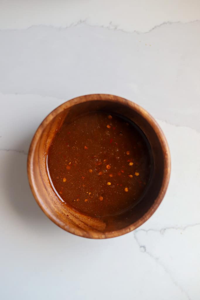 sriracha honey sauce in wooden bowl.