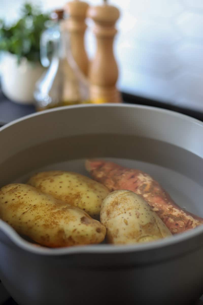 potatoes submerged in water in a pot