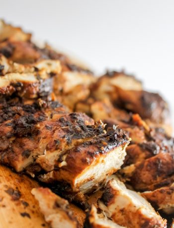 greek chicken breast on wooden board