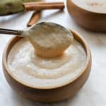 jamaican green banana porridge in wooden bowl with spoon.