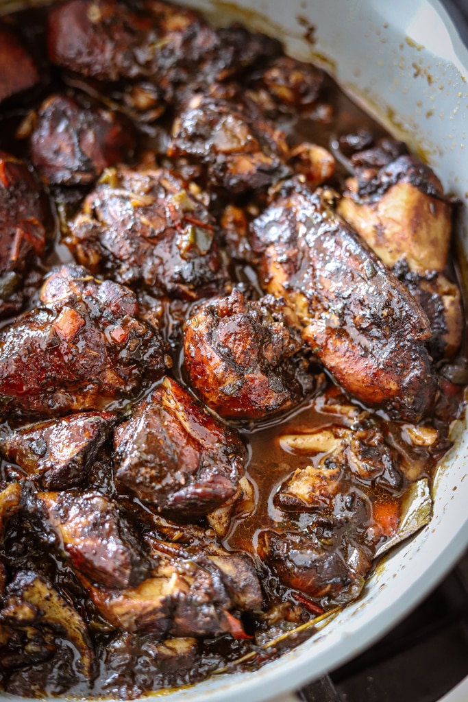 jamaican brown stew chicken in skillet.