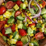 avocado salad in wooden bowl.
