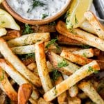 air fryer greek fries with tzatziki in tray.