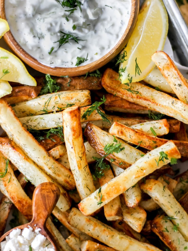 air fryer greek fries with tzatziki in tray.