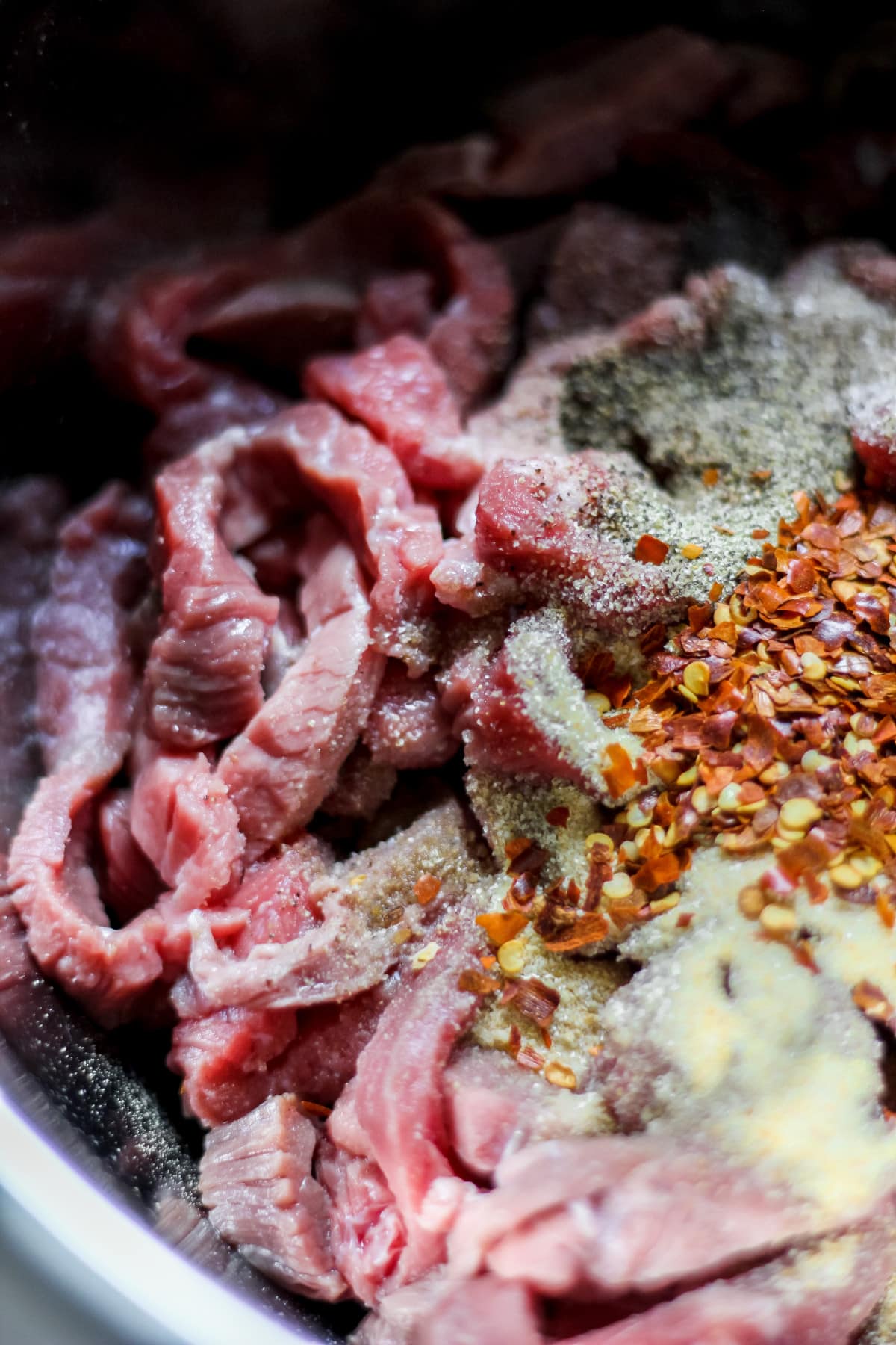 Raw beef strips with seasoning