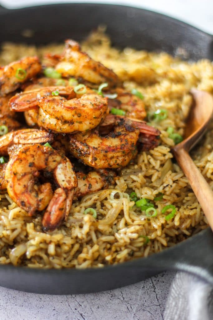Easy One Pot Cajun Shrimp & Rice in Cast Iron Skillet with Wooden Spoon
