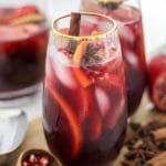 Spiced Autumn Apple Sangria in two glasses on wooden board