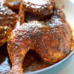 baked pesto chicken in teal lodge cast iron pan