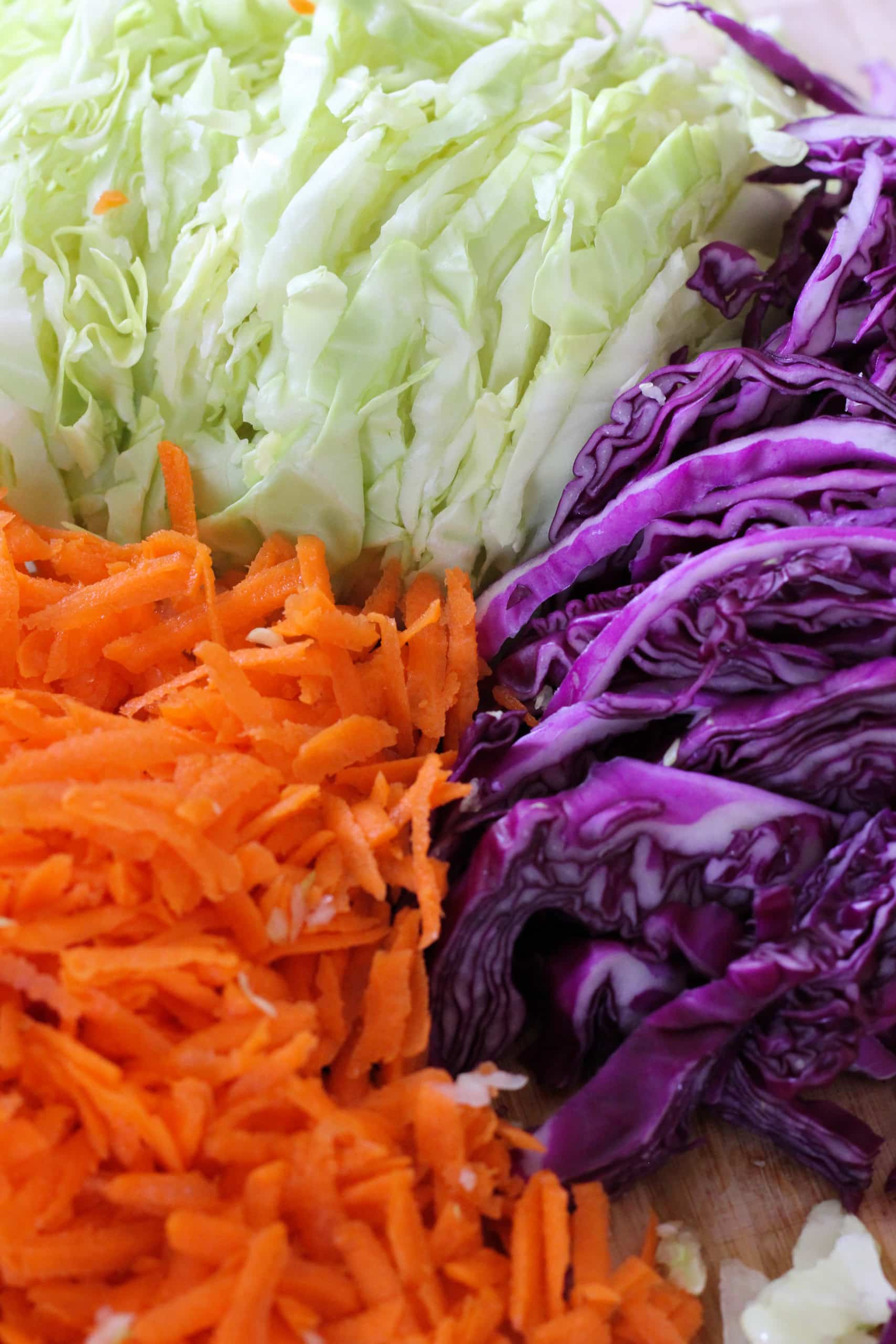 sliced carrots, red cabbage and green cabbage.