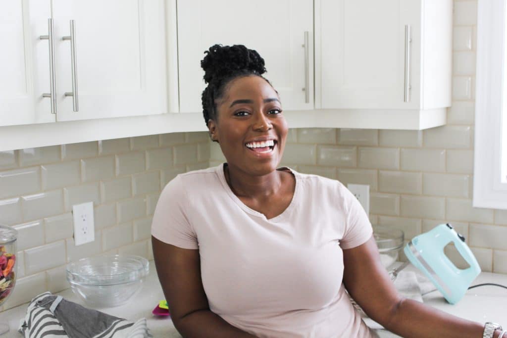 taneisha in the kitchen in pink shirt.