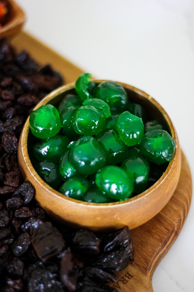 green glacé cherries in wooden bowl.
