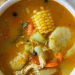 jamaican chicken soup in white bowl.