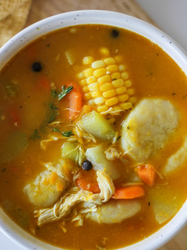 jamaican chicken soup in white bowl.