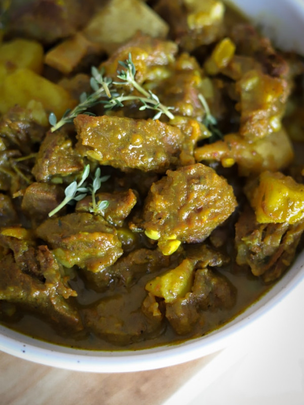 close up view of a bowl of curry goat