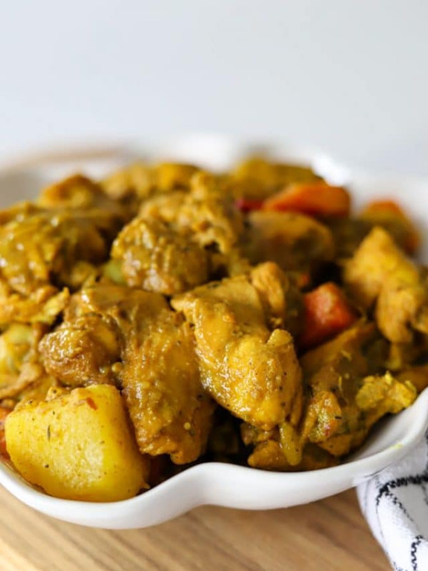 a bowl full of Jamaican curry chicken.