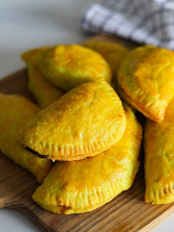 jamaican beef patties on a wooden board.