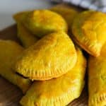 jamaican beef patties on a wooden board.