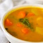 jamaican pumpkin soup in white bowl.