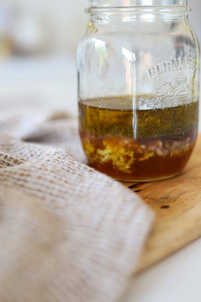 ingredients for honey mustard dressing in mason jar.