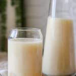 refreshing soursop juice over ice in glass.