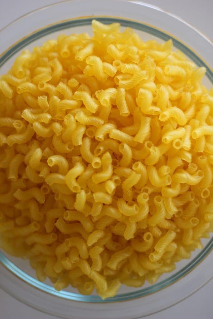 uncooked cavatappi pasta in bowl.
