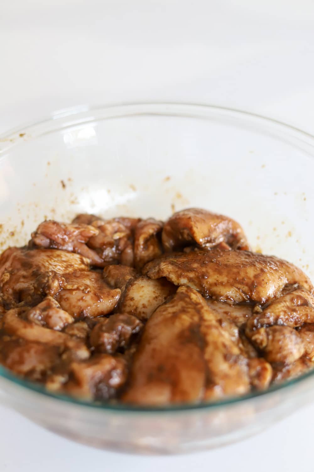 Chicken thighs marinating in homemade Jamaican jerk marinade for tacos