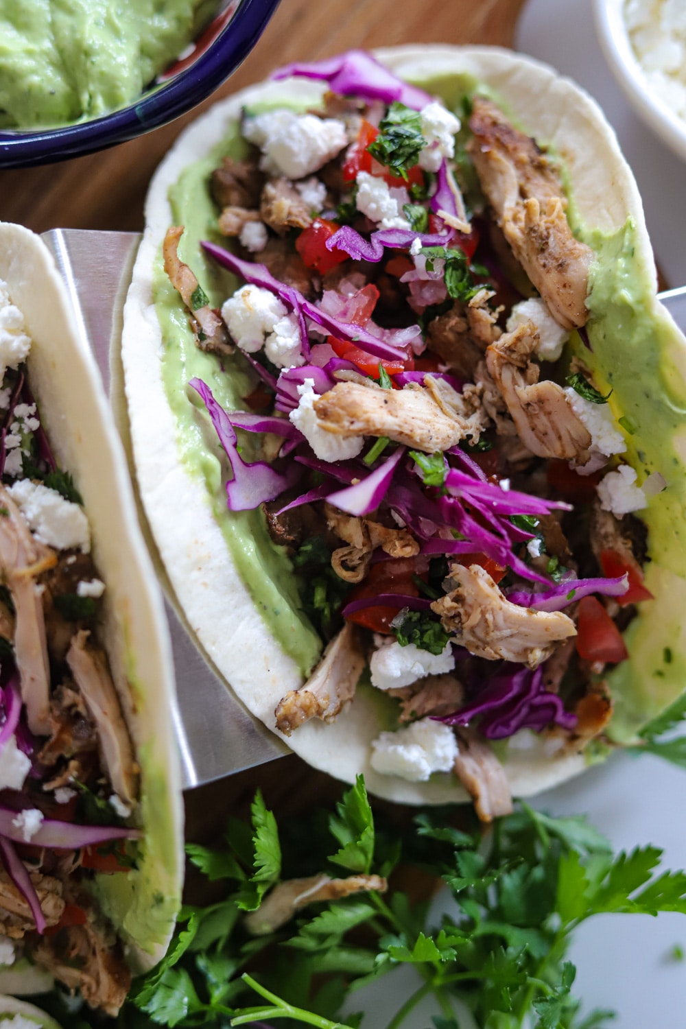 Jamaican jerk chicken tacos with avocado crema and fresh toppings