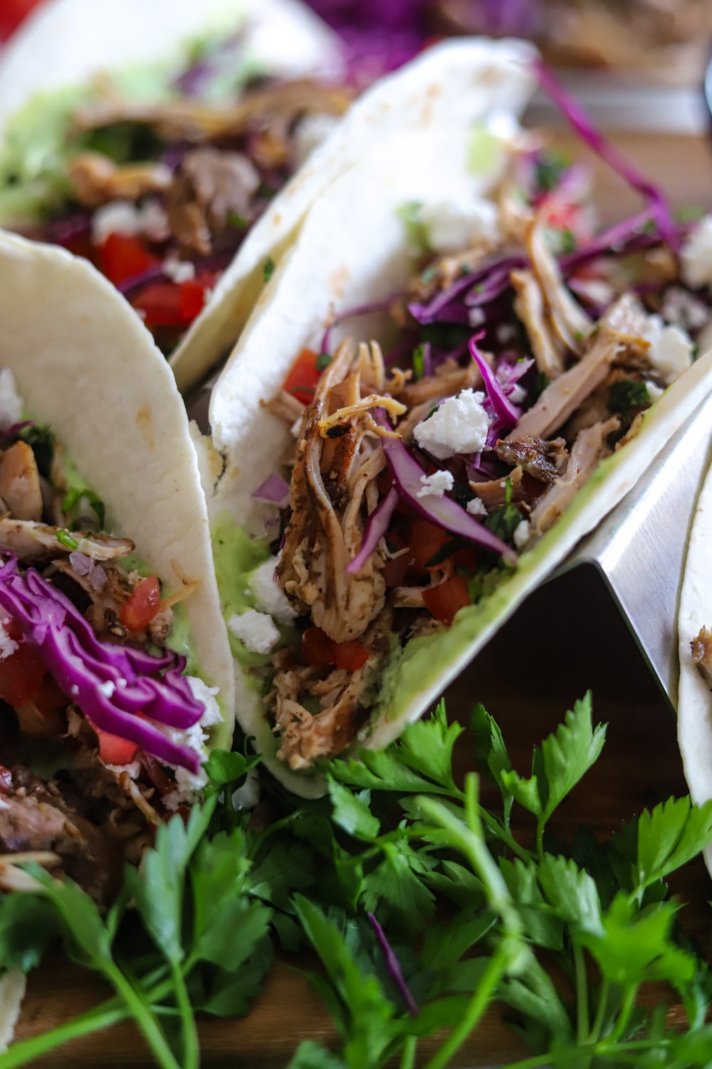 Loaded Jamaican jerk chicken tacos fully assembled with all toppings