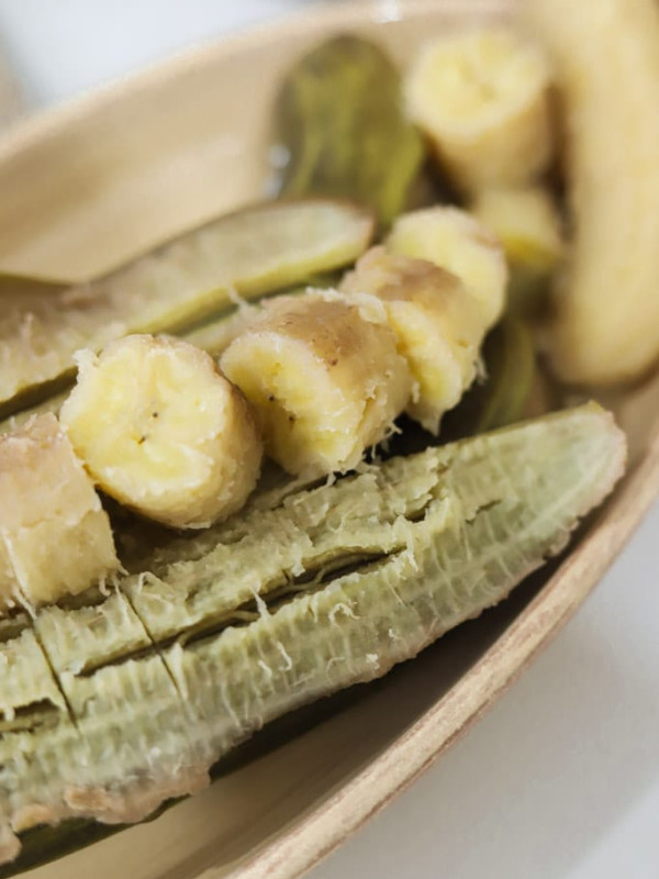 close up view of boiled green bananas with a few pieces sliced