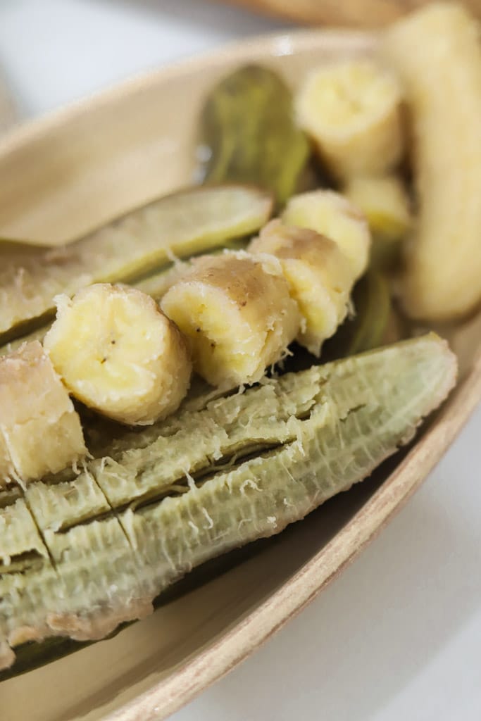 close up view of boiled green bananas with a few pieces sliced
