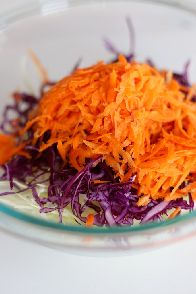 shredded green cabbage, purple cabbage and carrots.