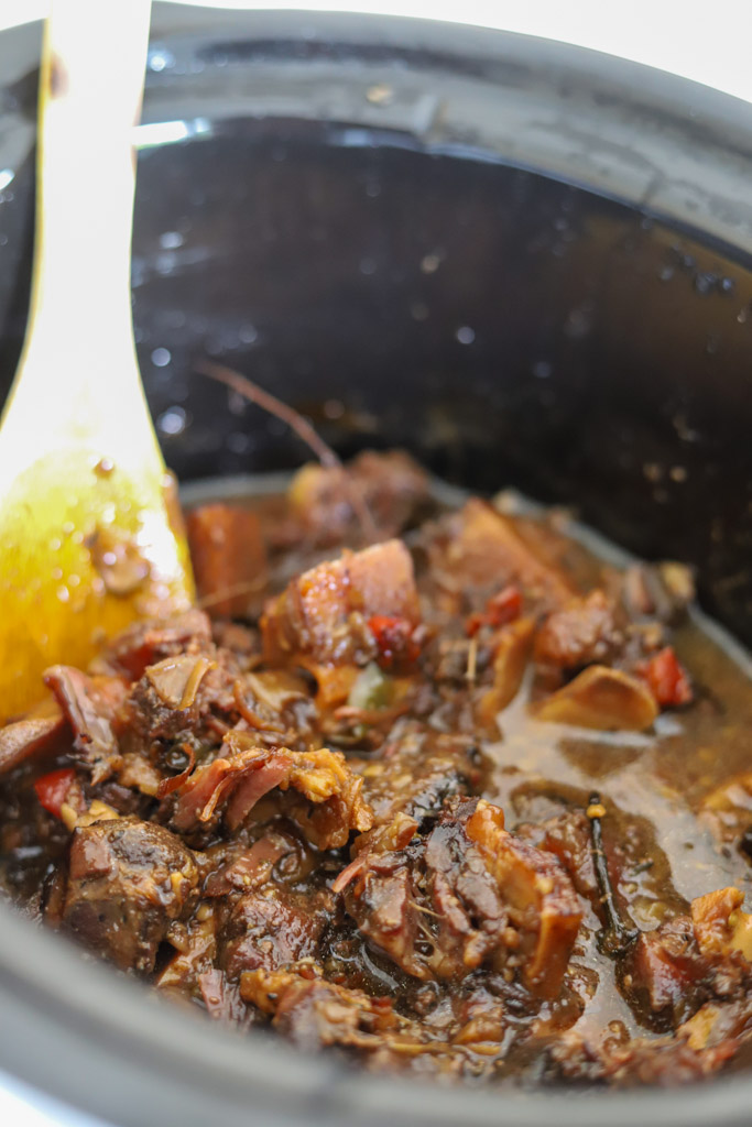 slow cooked jamaican oxtails in slow cooker pot.