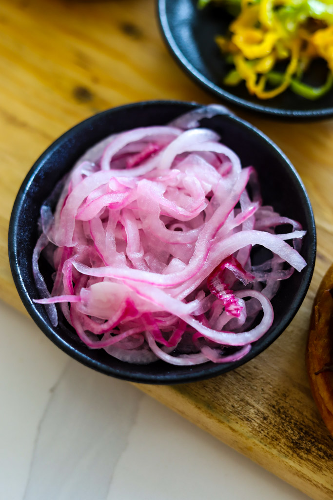 a bowl of red pickled onions.