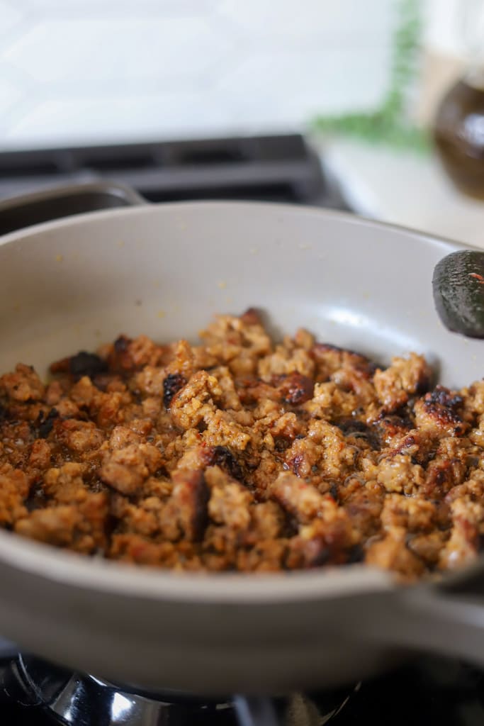 italian sausage browning in skillet.