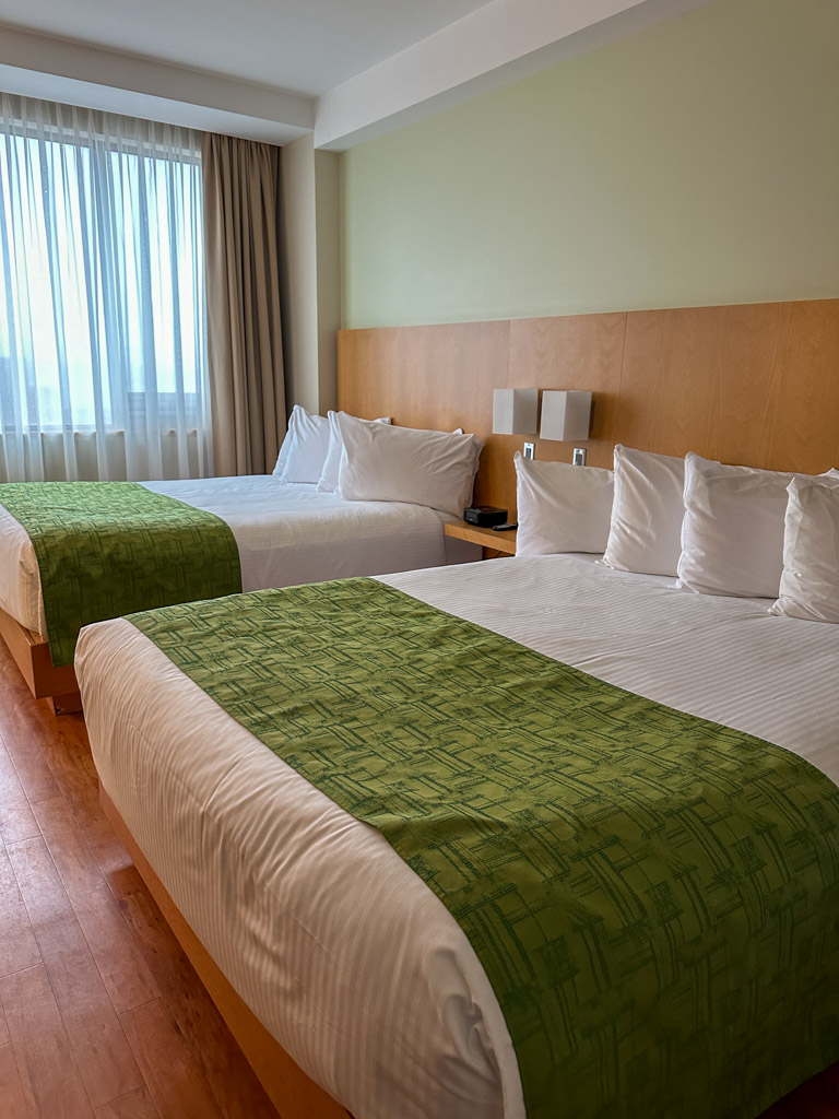 The Holman Grand Hotel room with two queen beds.