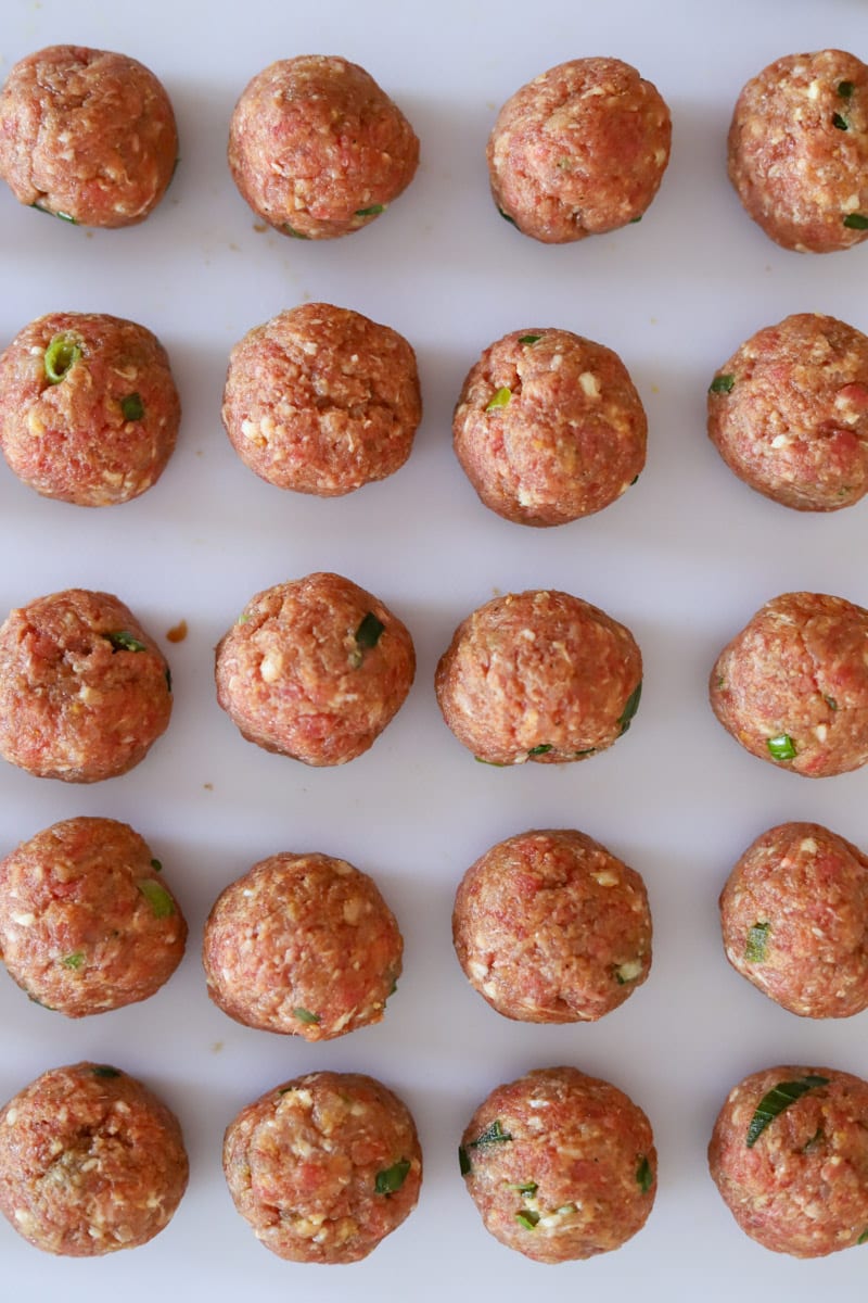 formed sweet and sour meatballs on baking sheet.