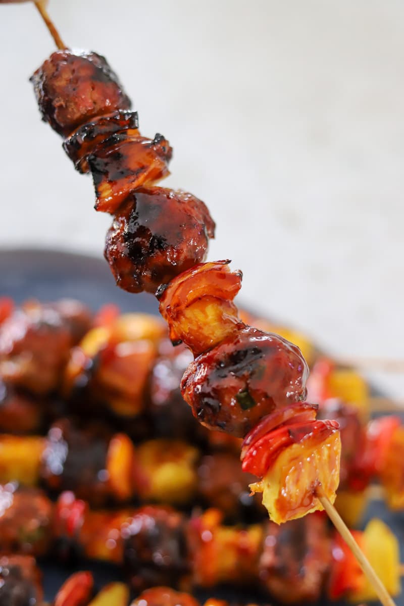 grilled sweet and sour meatballs on skewers.