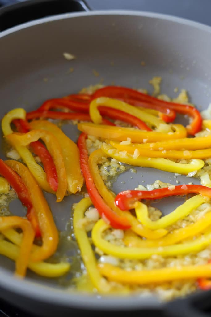 garlic and peppers sautéing in pan