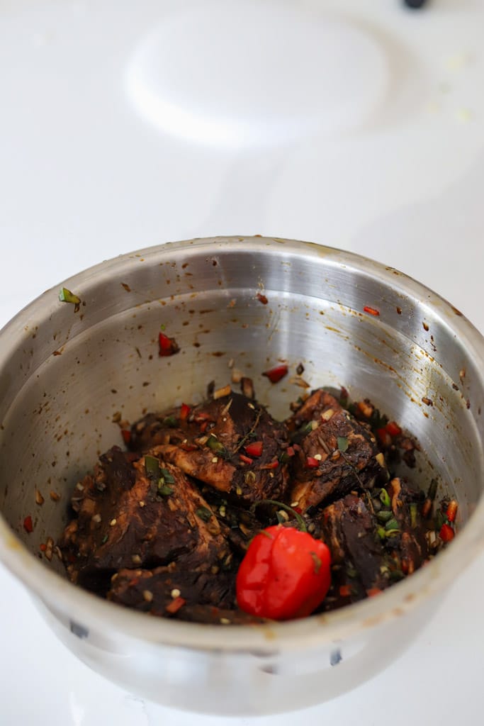 beef short ribs marinating in bowl.