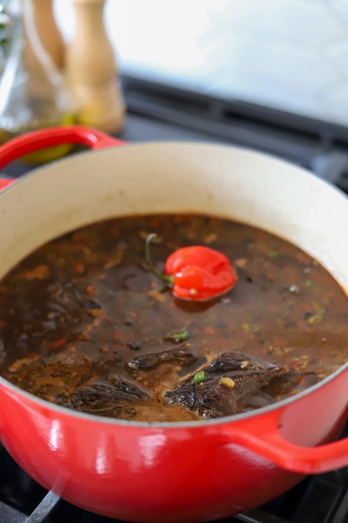 beef short ribs added to the liquid in pot.