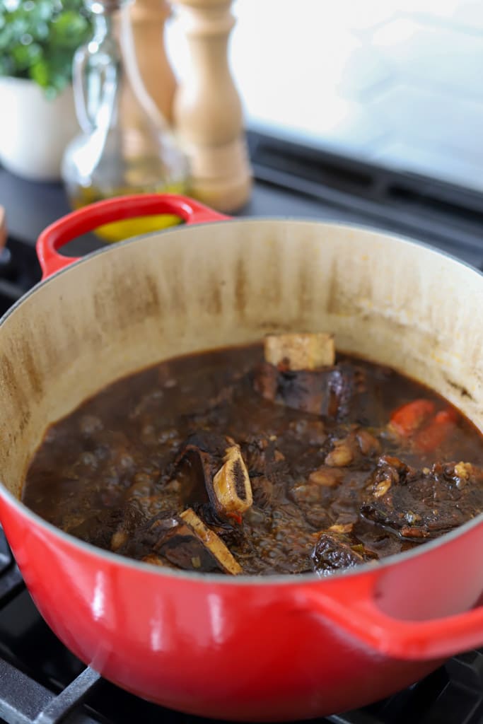 beef short ribs added to the liquid in pot.