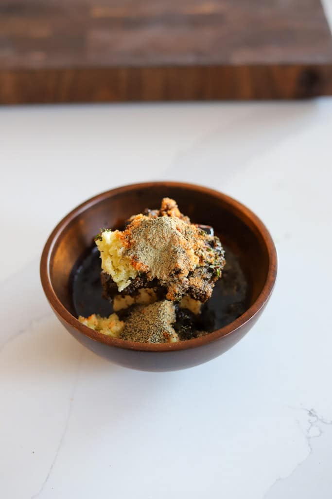 a small saucer containing jerk butter ingredients before mixing