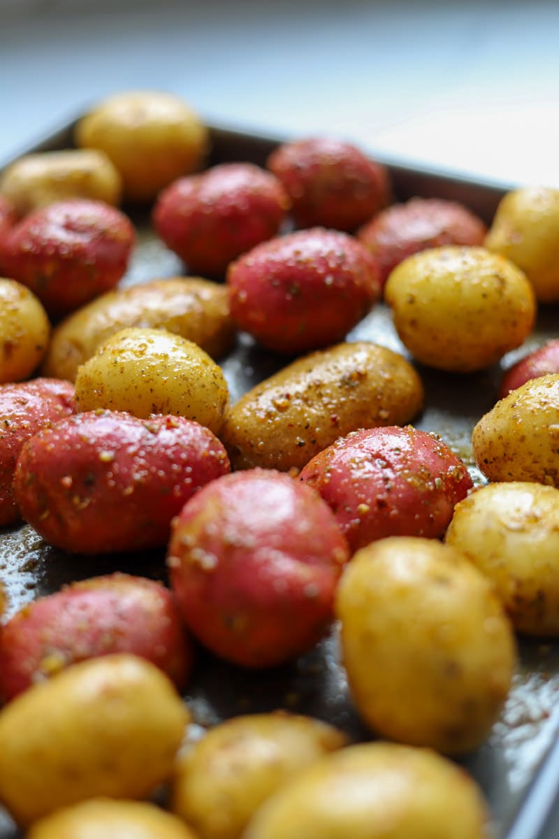 seasoned potatoes on a baking sheet