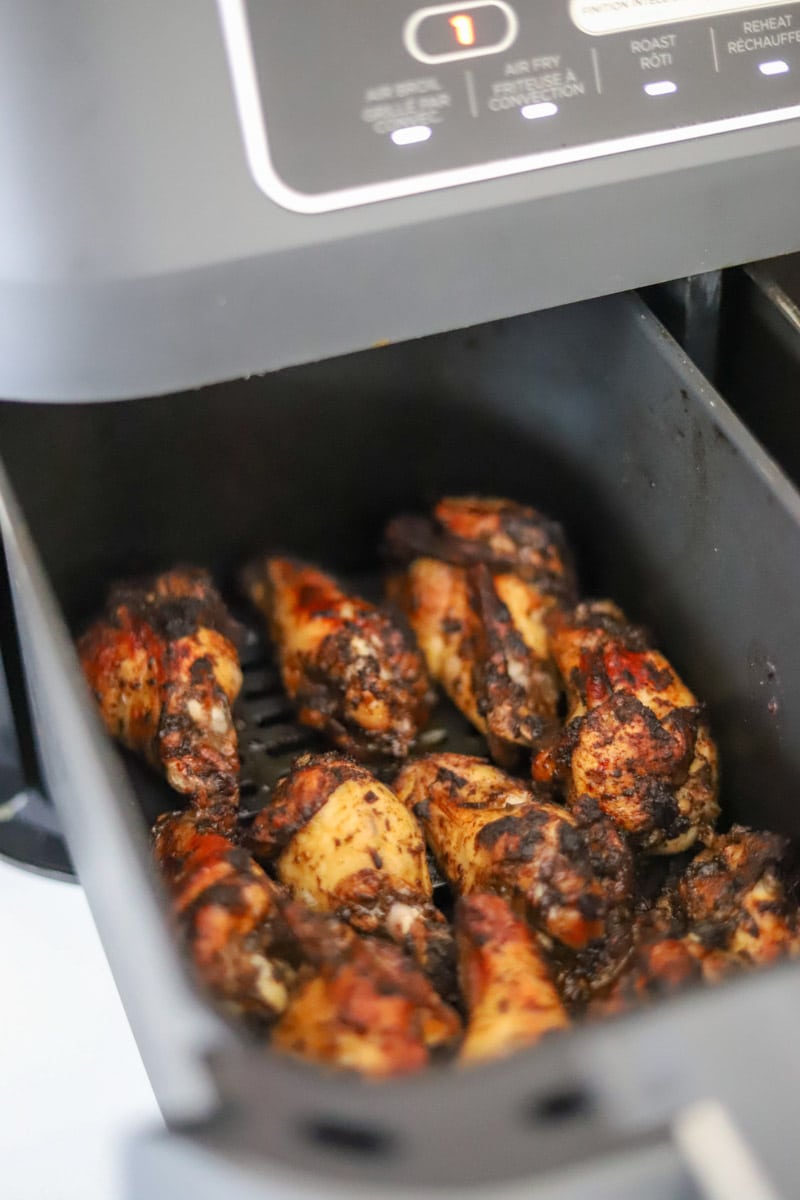 jerk chicken wings in an air fryer basket