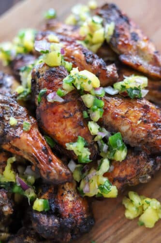 jerk chicken wings topped with pineapple sauce