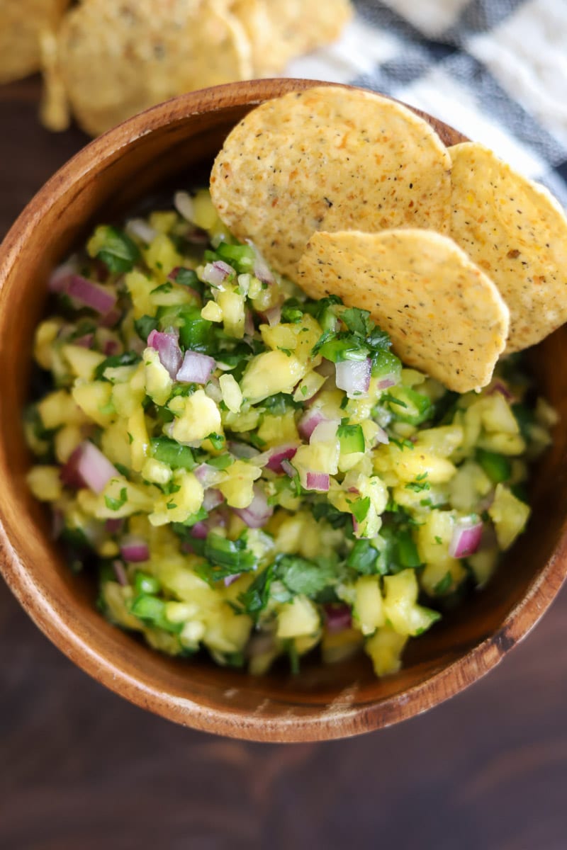 a bowl of salsa adorned with chips