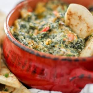 spinach dip in red bowl