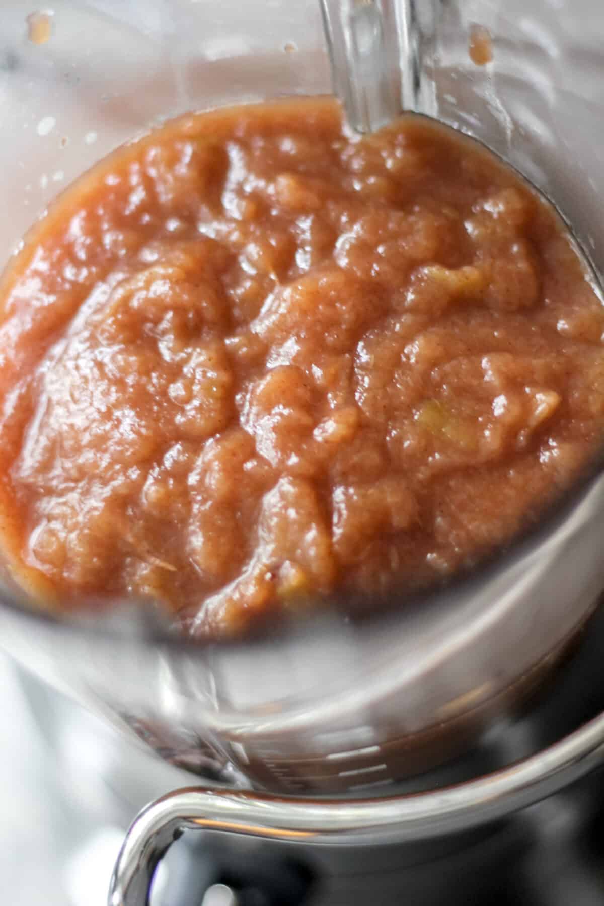 Thick apple butter mixture sitting in a blender jar before blending.