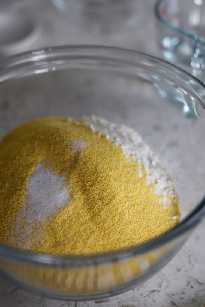 Mixing bowl with cornmeal, flour, and salt combined.