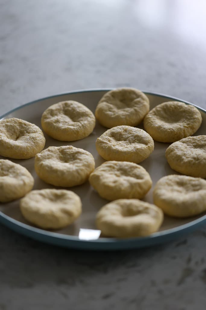 Plate of cooked dumplings arranged in a single layer.